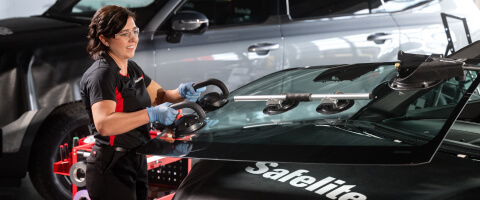 A Safelite technician installing a new windshield